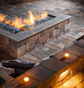 Outdoor living space residential fire pit with integrated accent lighting